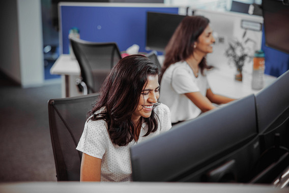 A woman sat at her desk, smiling
