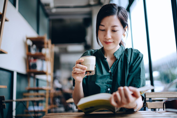 Woman reading with coffee